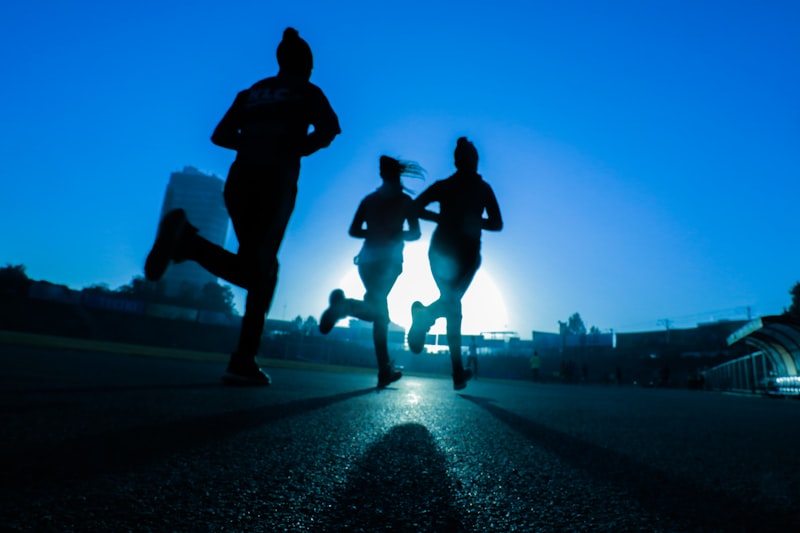 Athlete running on a mountain trail at sunrise