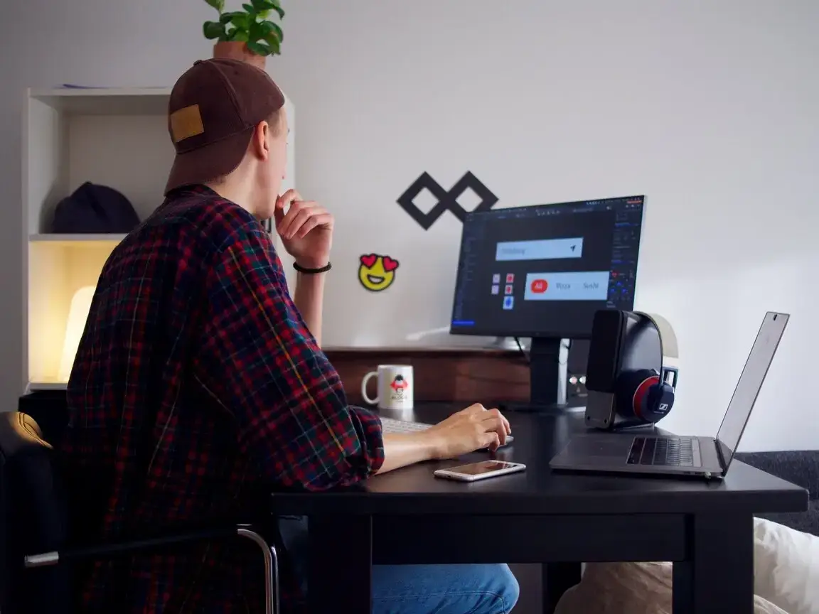 A person studies analytics on a laptop, surrounded by charts and graphs, representing a website optimisation strategy for online success