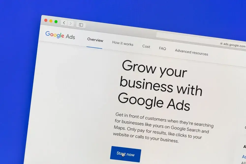 A person's hands holding a tablet displaying Google Ads reports, symbolizing how Google Ads can help advance business goals