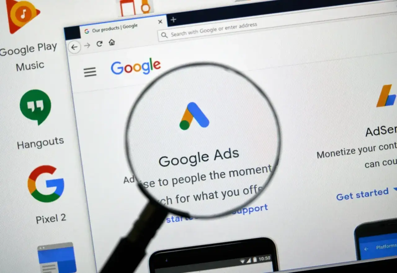 A magnifying glass hovering over various charts and data points, illustrating the critical steps of a Google Ads audit