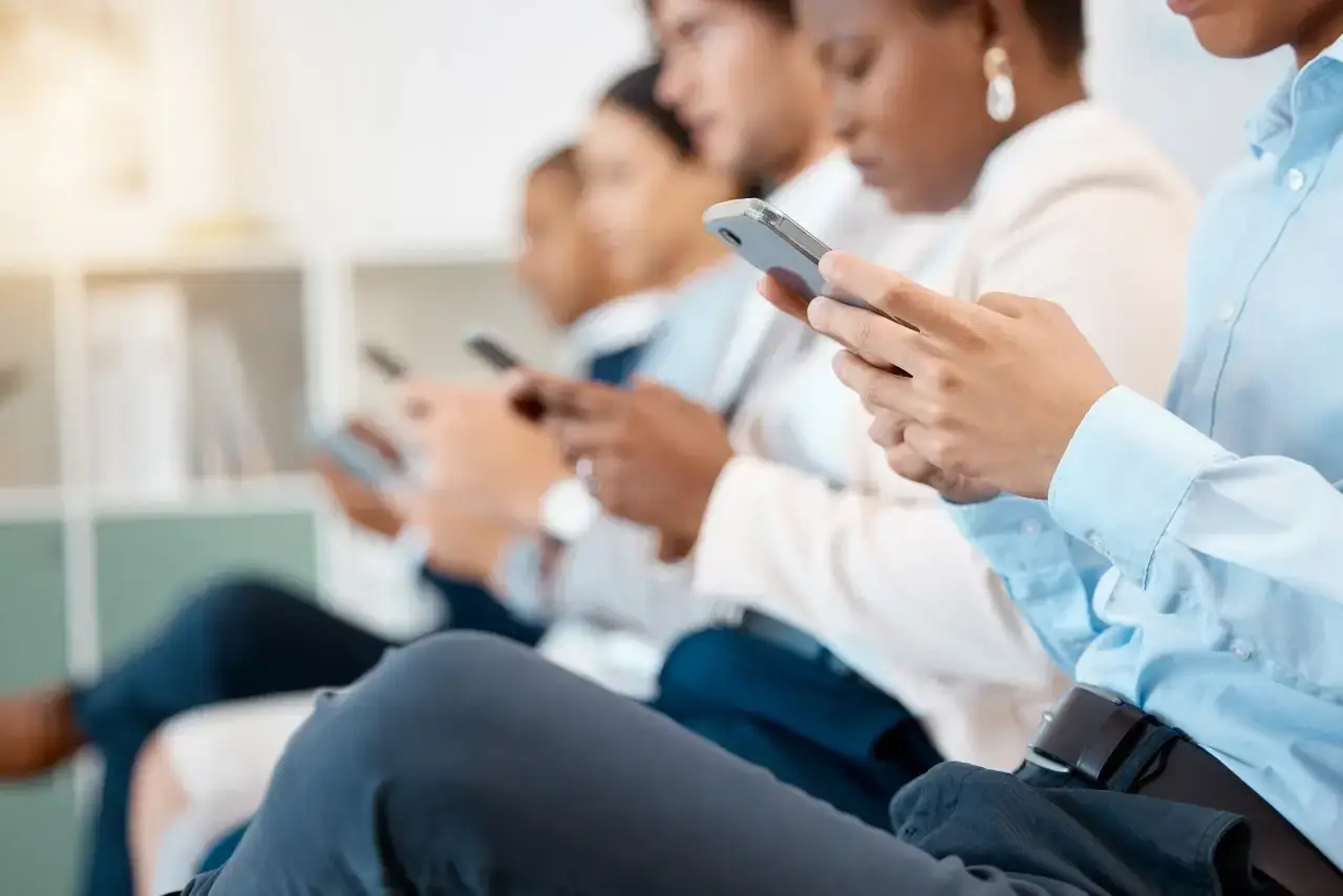 A magnifying glass peering at a laptop screen filled with Google Ads, illustrating how to see competitors' Google Ads