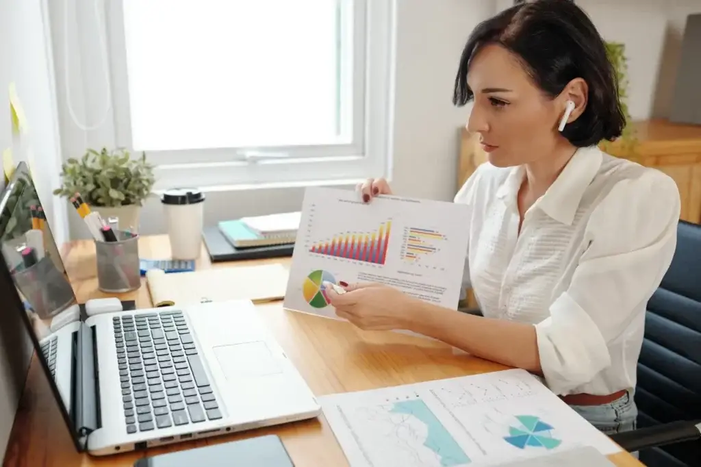 marketing professional analysing data with 'what is a digital marketing strategy' chart on desk.