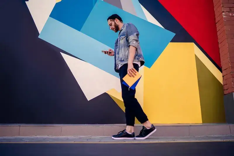 A diverse team of marketers huddle around a glowing tablet displaying search engine marketing (SEM) data, highlighting its benefits and hidden costs